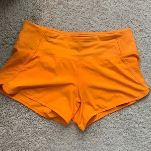 Orange Lululemon shorts 4"